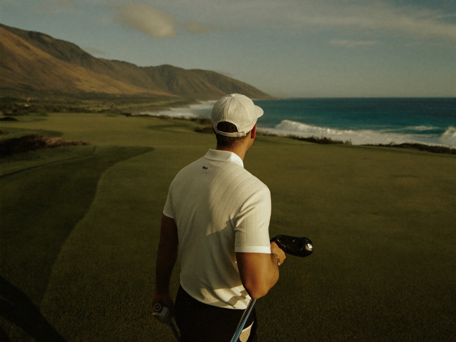 Ryan Byers looking out over the Pacific from a clifftop fairway at Kapalua, Maui